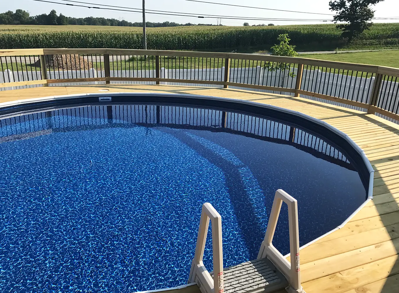 above-ground pool with a wooden deck built around it