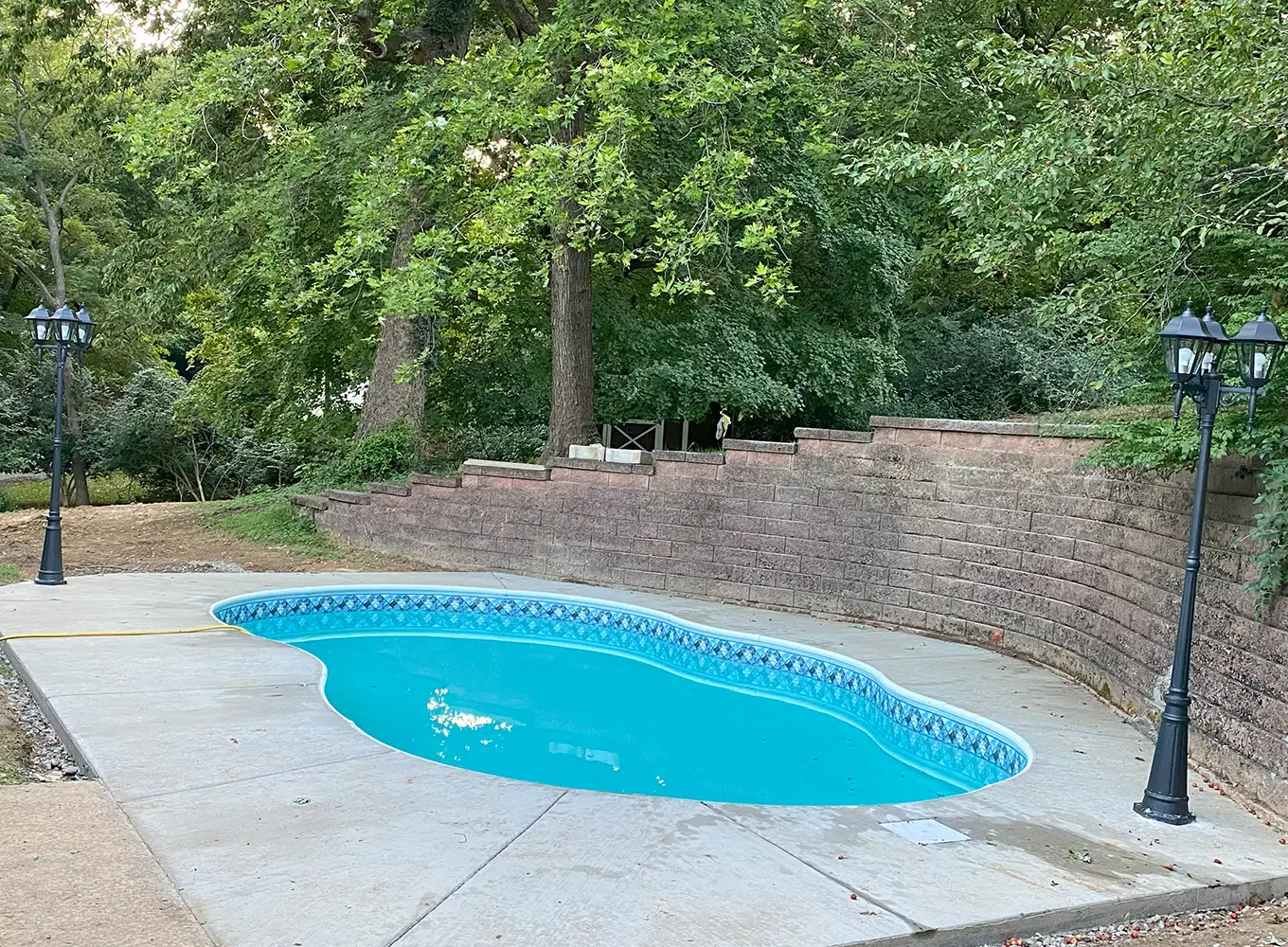 inground pool with a concrete patio edwardsville il